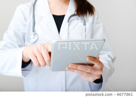 Female doctor with tablet Female doctor with tablet 6677861