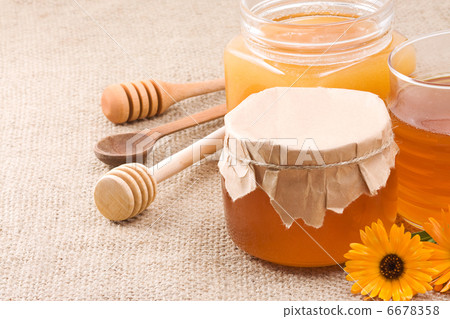 glass pot with honey on sack 6678358