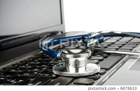 shiny stethoscope at notebook laptop isolated on white shiny stethoscope at notebook laptop isolated on white 6678610
