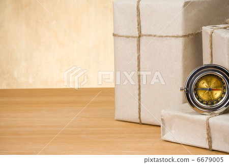 parcel wrapped and compass on wood parcel wrapped and compass on wood 6679005