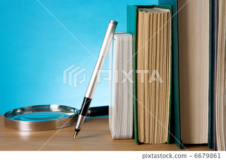 books, magnifier and ink pen on wood books, magnifier and ink pen on wood 6679861
