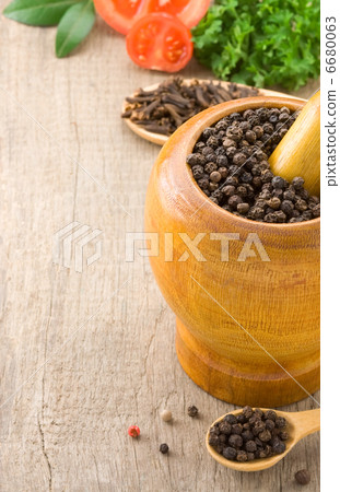 pepper in mortar with pestle and spices 6680063