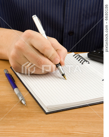male hand writing by pen on notebook 6680186