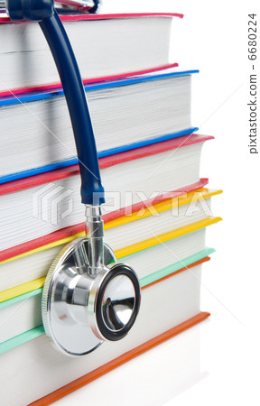 pile of books and stethoscope isolated on white 6680224