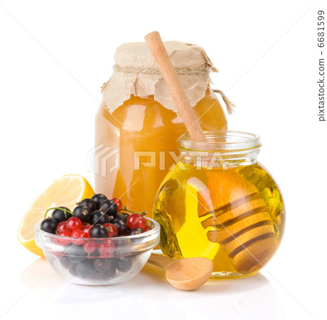 glass jar full of honey and berry glass jar full of honey and berry 6681599