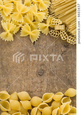 raw pasta on wood background raw pasta on wood background 6681637