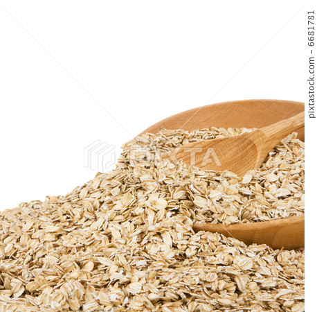 cereal flakes and wood spoon in plate 6681781