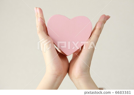 Hand of a woman holding a heart Hand of a woman holding a heart 6683381