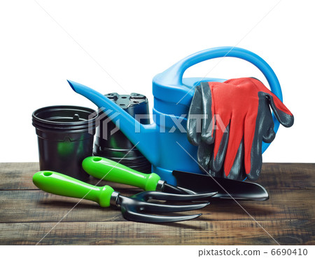 garden tools lying on wooden table isolated garden tools lying on wooden table isolated 6690410