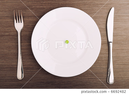 diet concept. one pea on an empty white plate 6692482