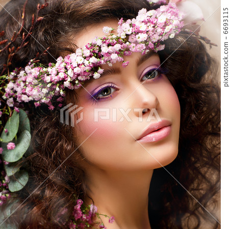 Closeup Portrait of Pretty Woman with Wreath of Pink Flowers. Natural Beauty Closeup Portrait of Pretty Woman with Wreath of Pink Flowers. Natural Beauty 6693115