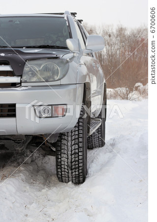 Snowy winter road ahead an unrecognizable car 6700606