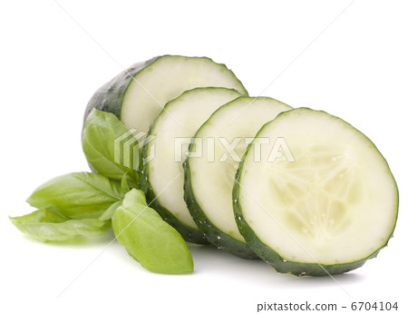 Sliced cucumber vegetable and basil leaves still life 6704104