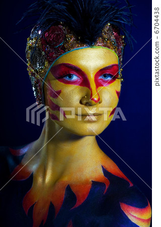 Portrait of a mysterious woman with artistic make-up on her body 6704438
