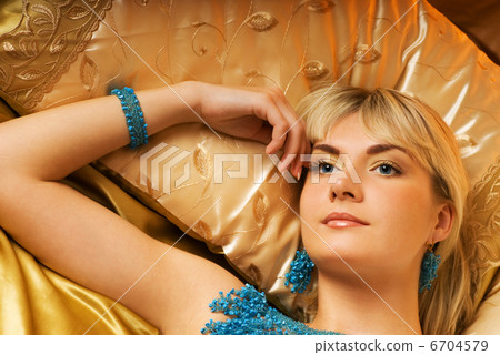 Beautiful blond girl lying in a bed Beautiful blond girl lying in a bed 6704579