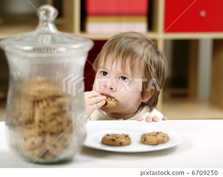 Little boy eating cookies Little boy eating cookies 6709250