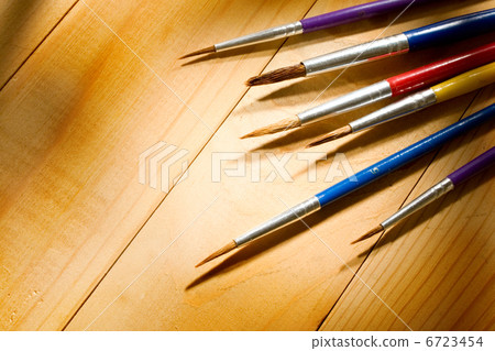 Paintbrushes isolated on wooden background 6723454