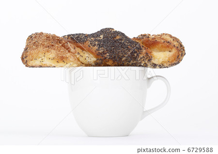 Sesame bun on a cup of coffee Sesame bun on a cup of coffee 6729588