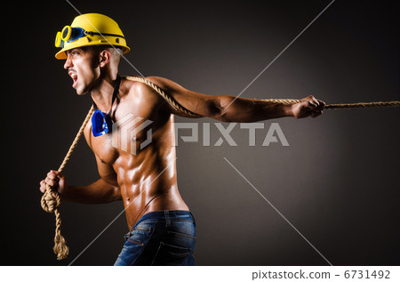 Nude builder pulling rope in darkness Nude builder pulling rope in darkness 6731492