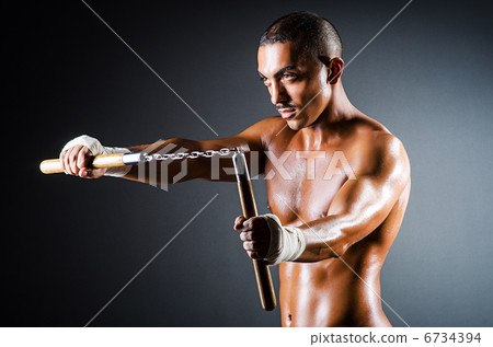 Strong man with nunchaku 6734394