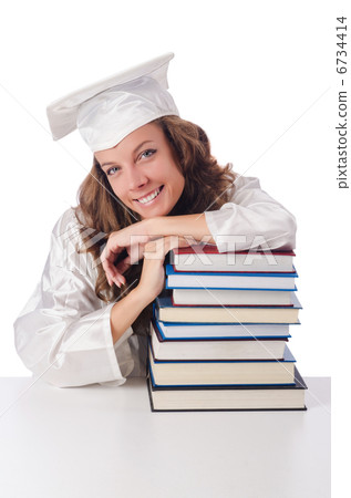 Happy graduate with lots of books on white 6734414