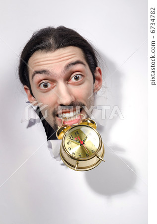 Man with clock through hole in paper Man with clock through hole in paper 6734782