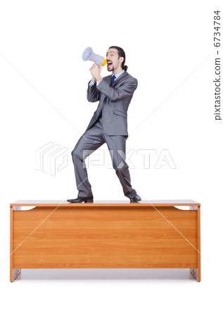 Businessman with loudspeaker at the desk Businessman with loudspeaker at the desk 6734784