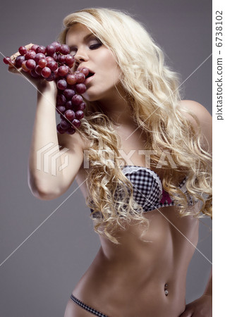 young beautiful blonde posing with grape, studio shot young beautiful blonde posing with grape, studio shot 6738102