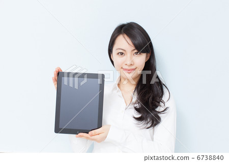A woman showing a tablet PC A woman showing a tablet PC 6738840