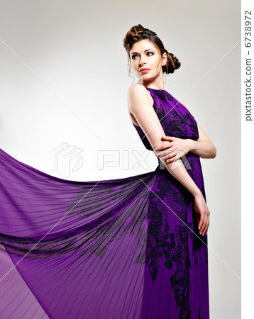 Beautiful fashion woman in violet long dress Beautiful fashion woman in violet long dress 6738972