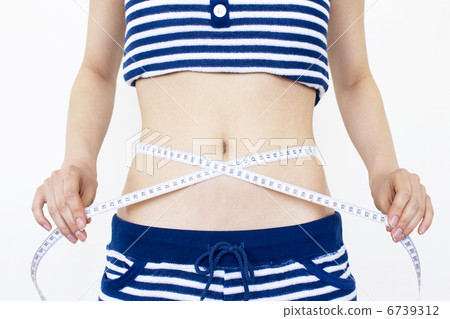 A woman measuring the waist A woman measuring the waist 6739312