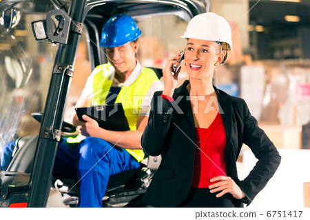 Forklift driver and supervisor at warehouse 6751417