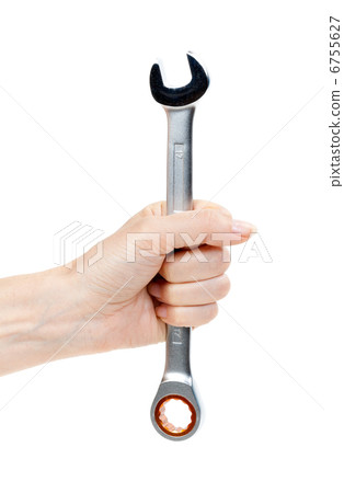 Woman's hand holding a chrome wrench. 6755627