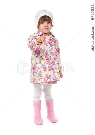 little girl in boots and a jacket shows finger 6755821
