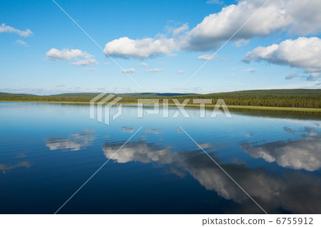 Calm beautiful rural landscape with a lake and sky reflected 6755912