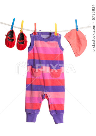 A set of children's clothes hanging on a clothesline. 6755924