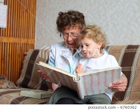 Grandmother reading book to the granddaughter 6760362