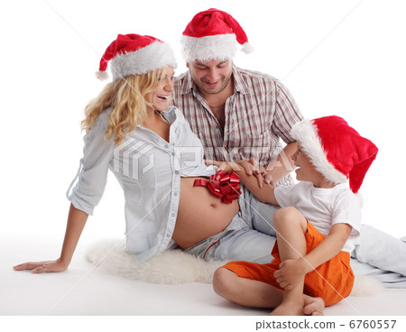 Father, son and pregnant mother in christmas hat Father, son and pregnant mother in christmas hat 6760557
