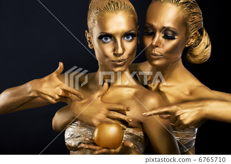 Masquerade. Enjoyment. Two Glossy Women with Golden Body Art. Glamor Masquerade. Enjoyment. Two Glossy Women with Golden Body Art. Glamor 6765710