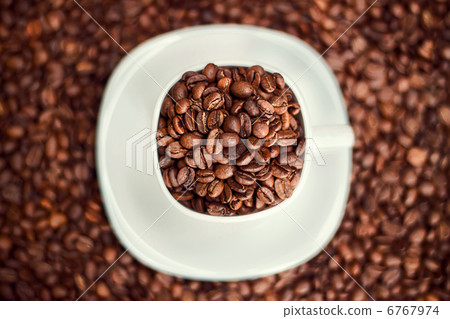 White cup filled with coffee beans White cup filled with coffee beans 6767974