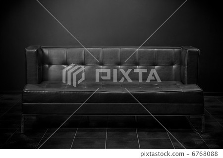 Old black sofa in dark room 6768088