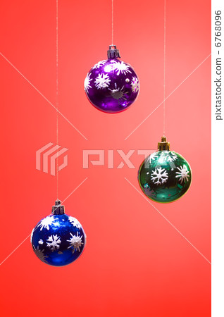 three xmas balls on red background vertical 6768096