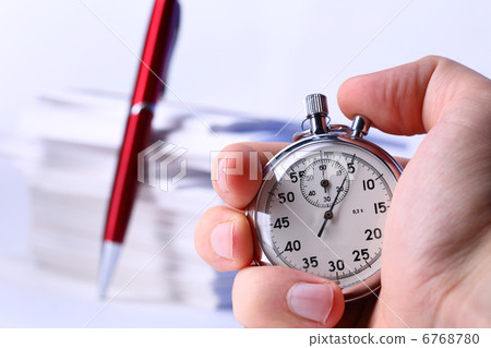 Stopwatch in hand on background of paper cards 6768780