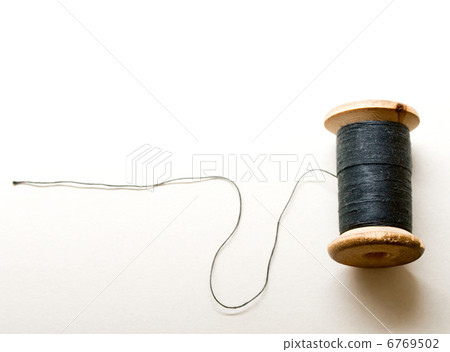 Thread bobbin on white background 6769502