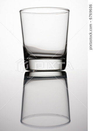 An empty glass on a grey background 6769686