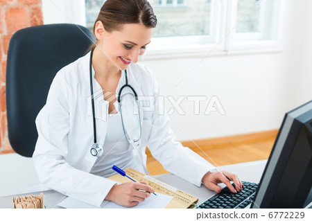 doctor at desk in clinic writing a file or dossier doctor at desk in clinic writing a file or dossier 6772229