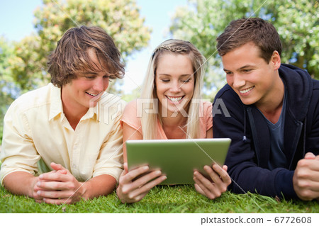 Three students using a tactile tablet Three students using a tactile tablet 6772608