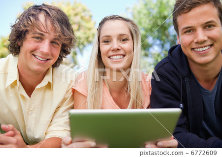 Portrait of three students using a tactile tablet Portrait of three students using a tactile tablet 6772609