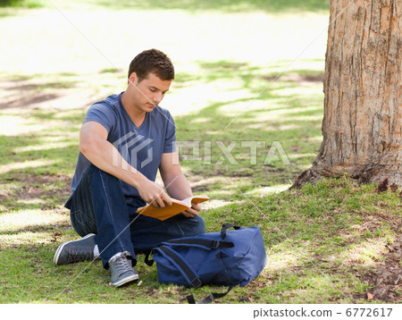 Student reading a textbook Student reading a textbook 6772617