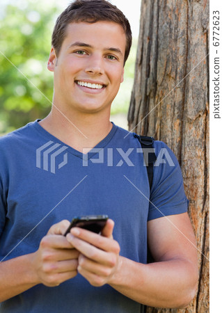 Portrait of a muscled student with a smartphone Portrait of a muscled student with a smartphone 6772623